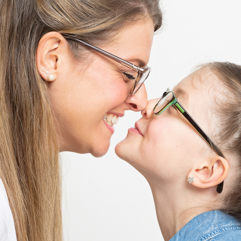 a mother and daughter pose nose to nose for a fun portrait shot