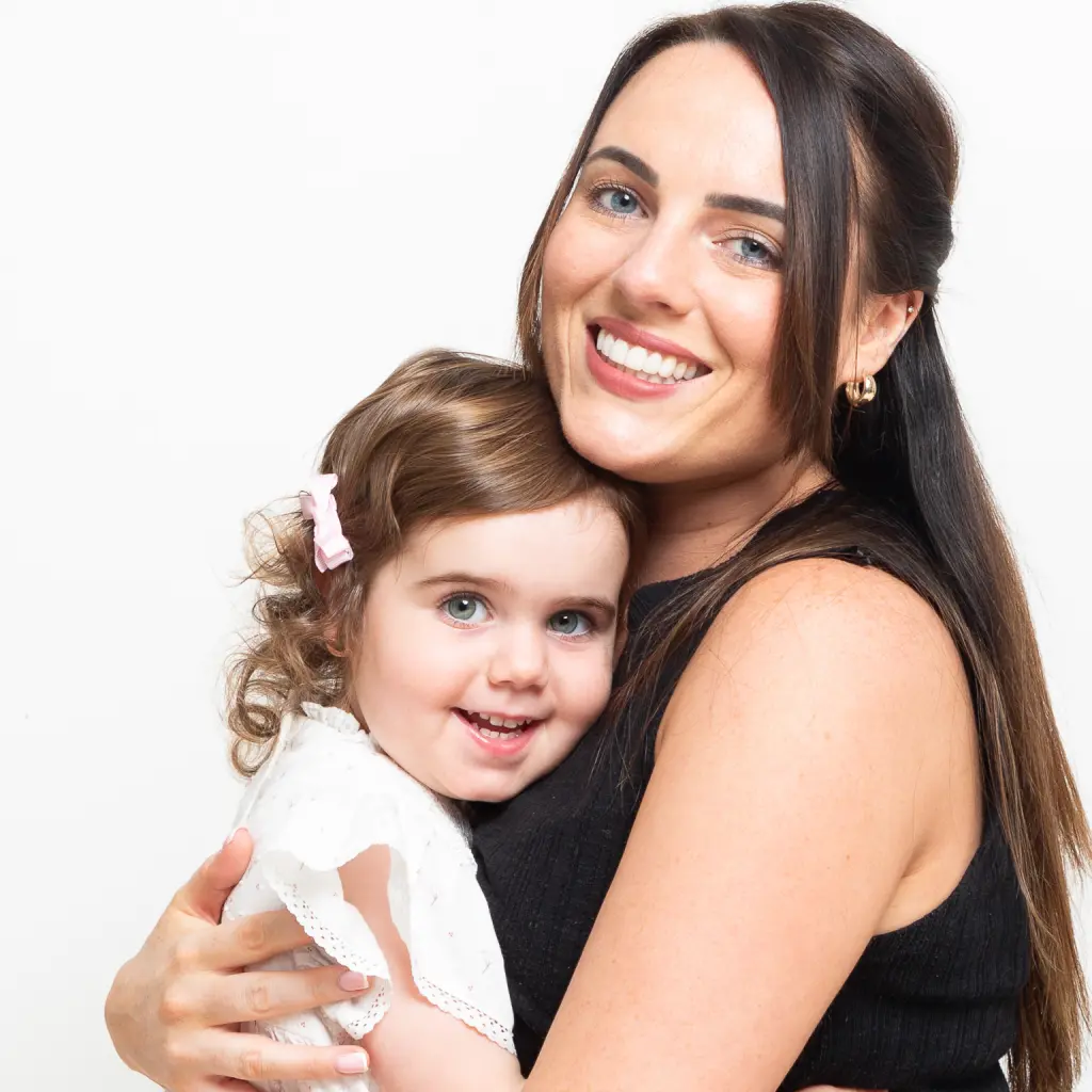 a mother and daughter share a cuddle at a photo shoot