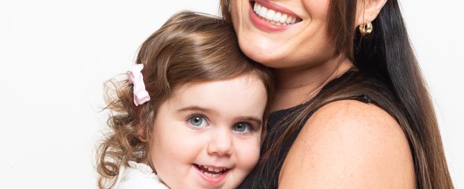 a mother and daughter share a cuddle at a photo shoot
