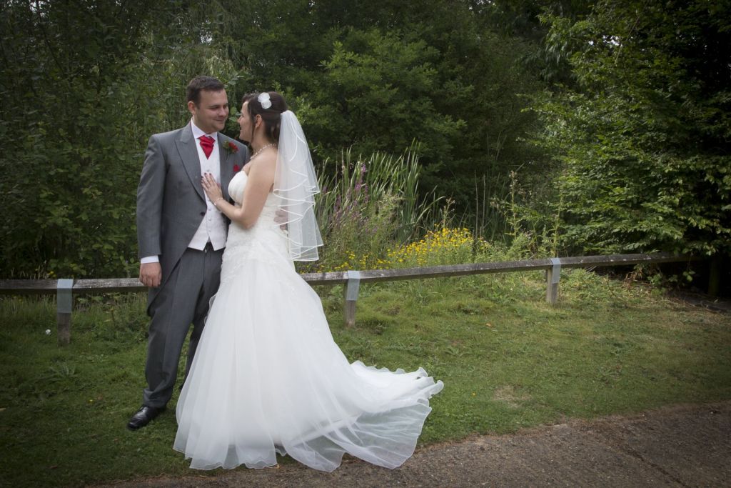 a bride and groom look at each other in a wedding photograph