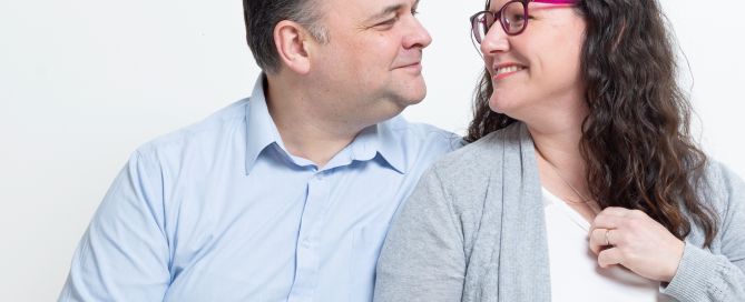 a couple look at each other in a portrait shoot