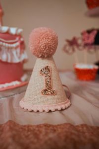 a pink first birthday party hat