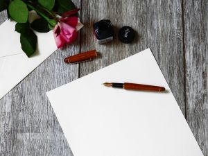 a pen and paper set out ready to write a letter