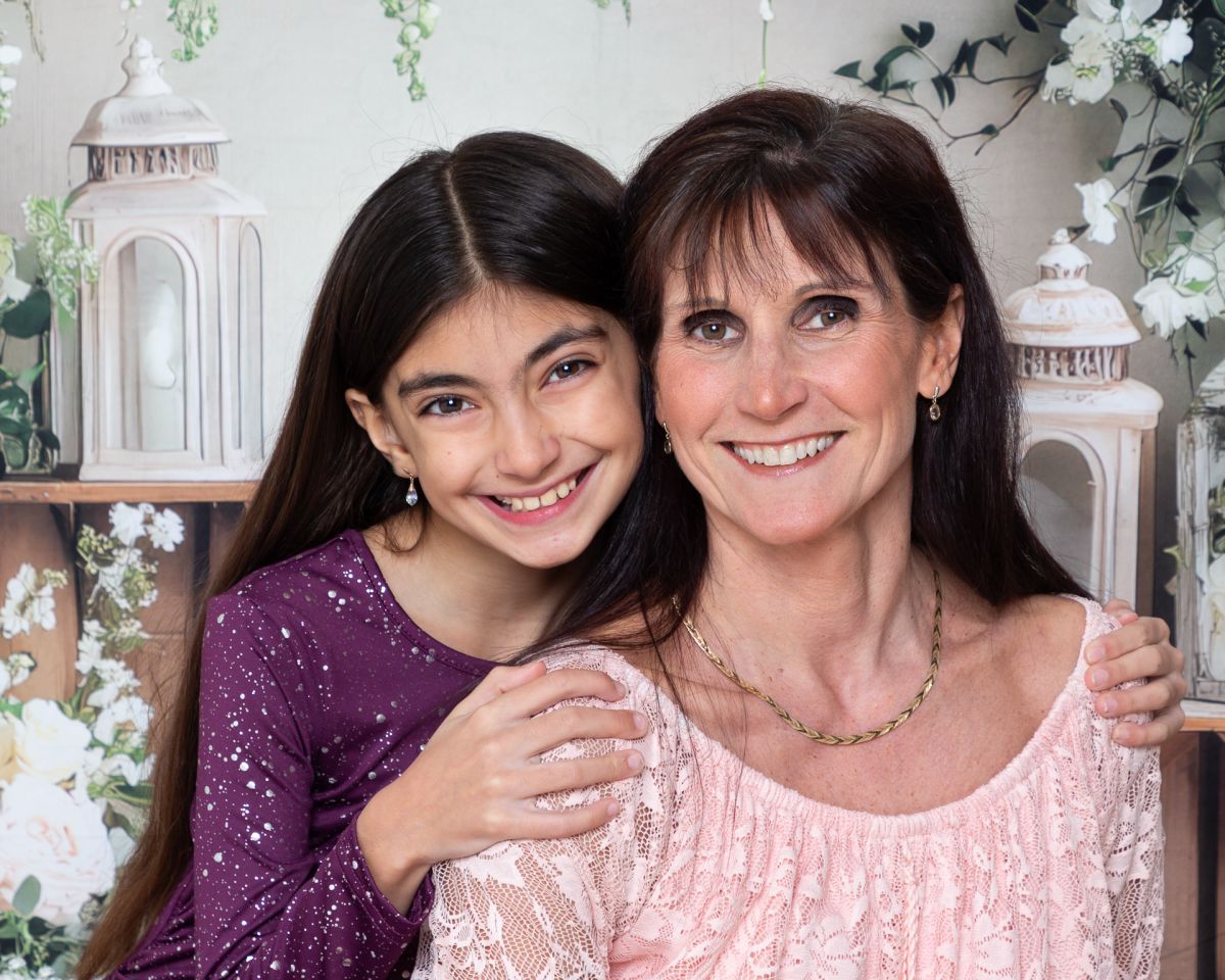 mother and daughter pose at a mother's day photo shoot