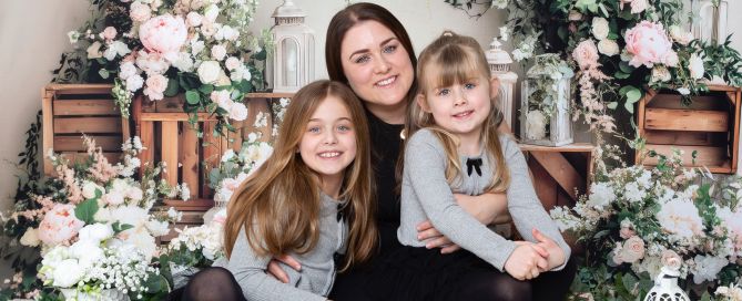 a mum and her daughters pose at a mother's day photo shoot