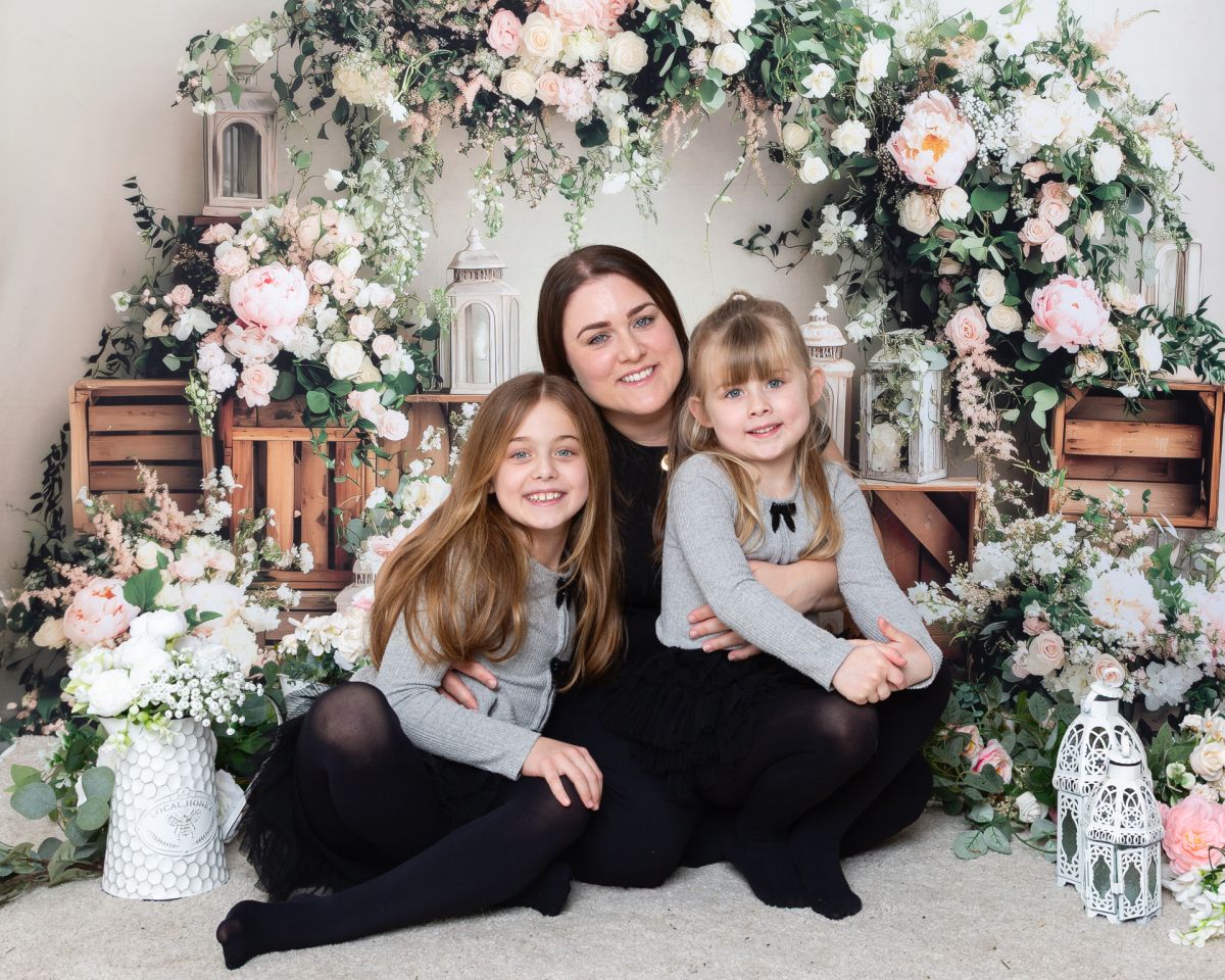 a mum and her daughters pose at a mother's day photo shoot