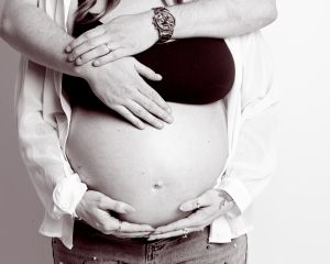 maternity portrait image in black and white of a couple standing together