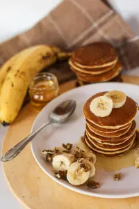 a stack of pancakes and bananas