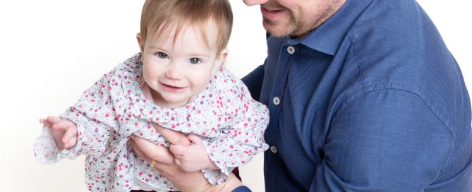 a little girl and her dad playing airplanes
