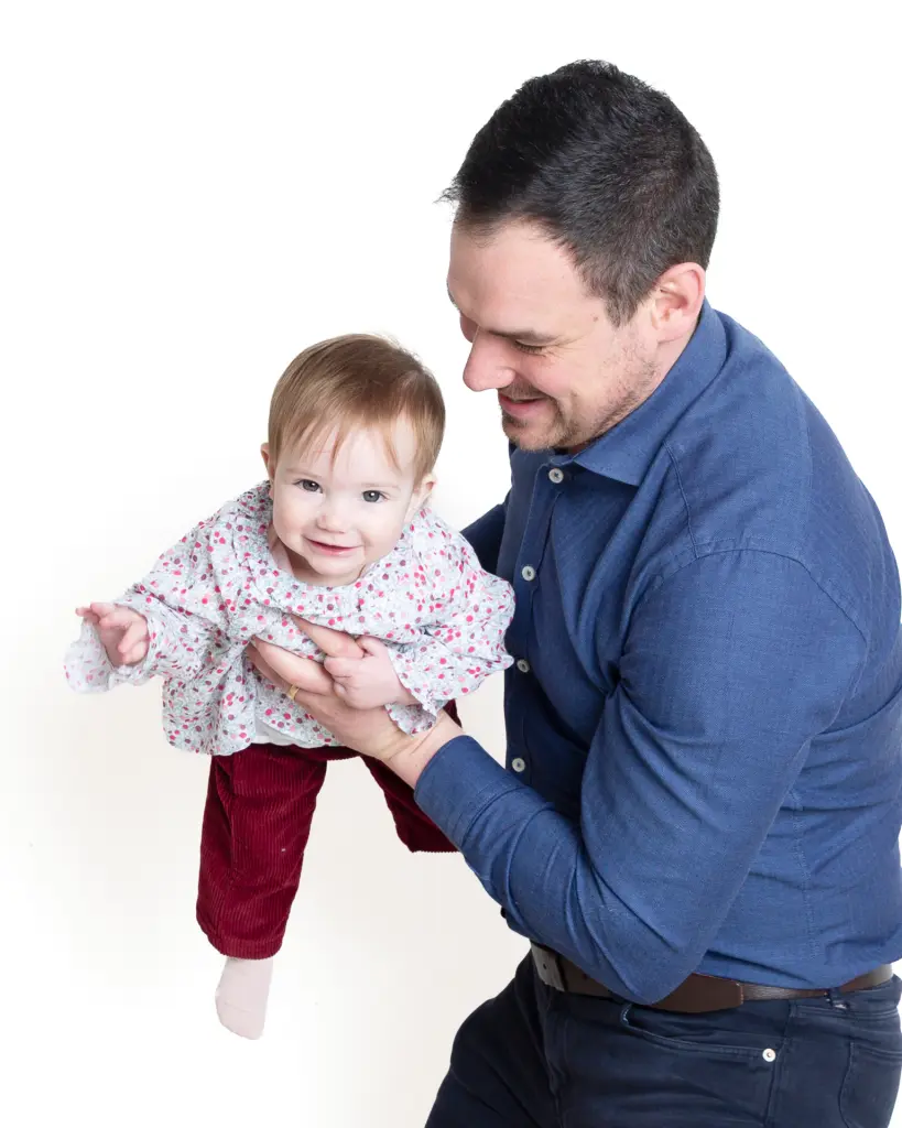 a little girl and her dad playing airplanes