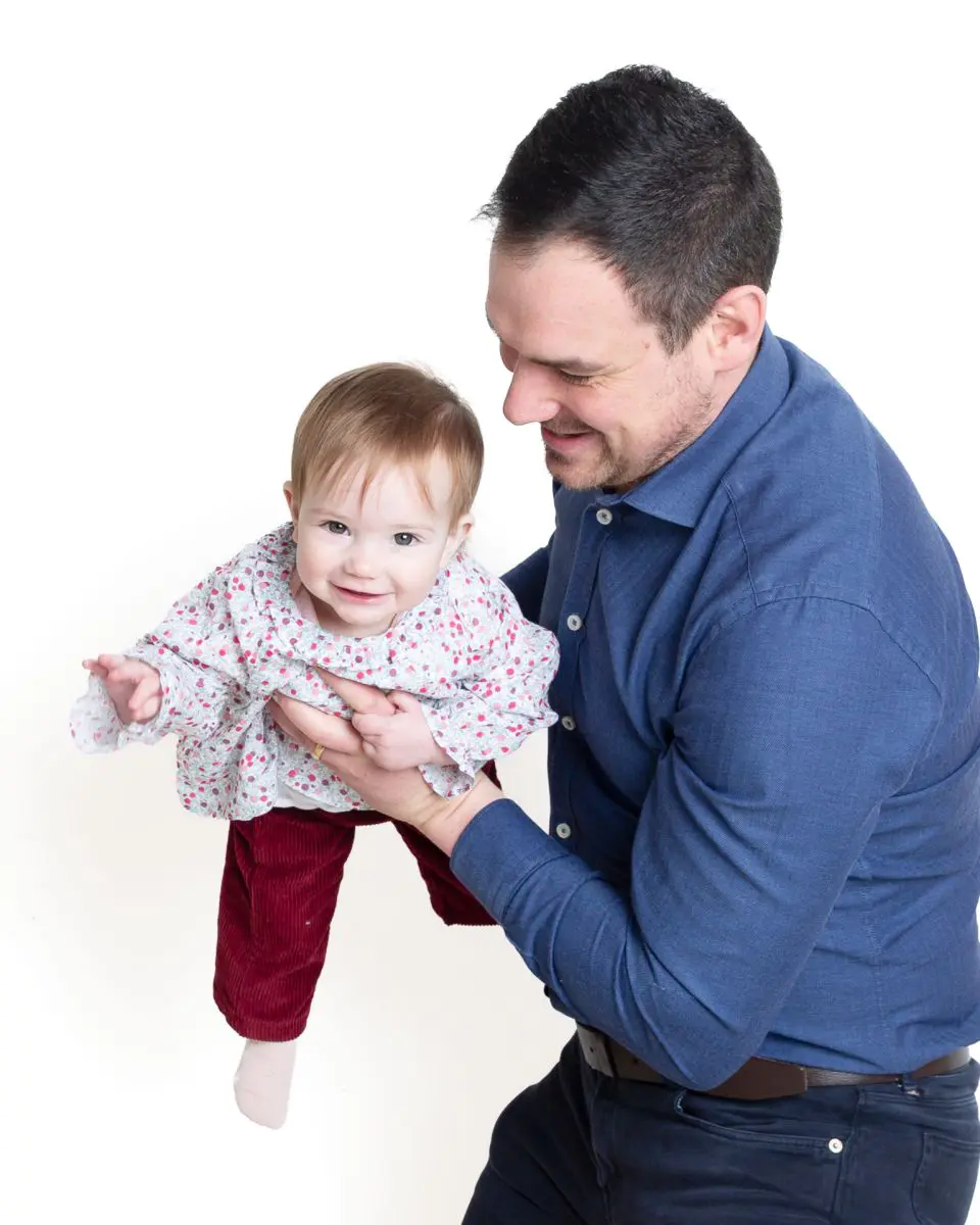 a little girl and her dad playing airplanes