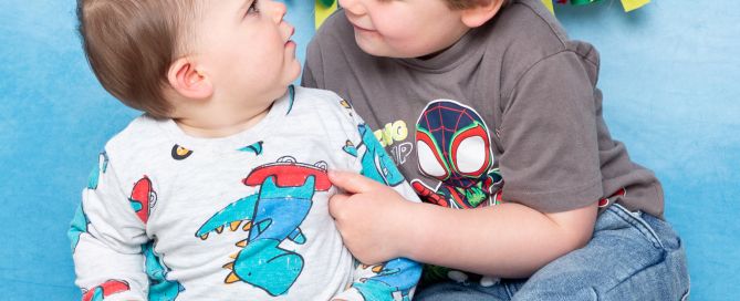 two brothers look at each other in a photo shoot