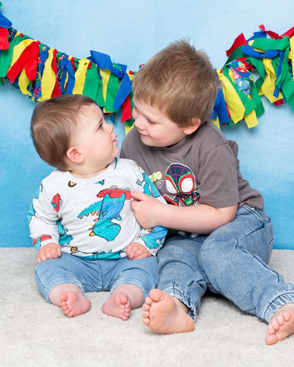 Portrait Photography West Sussex two brothers look at each other in a photo shoot