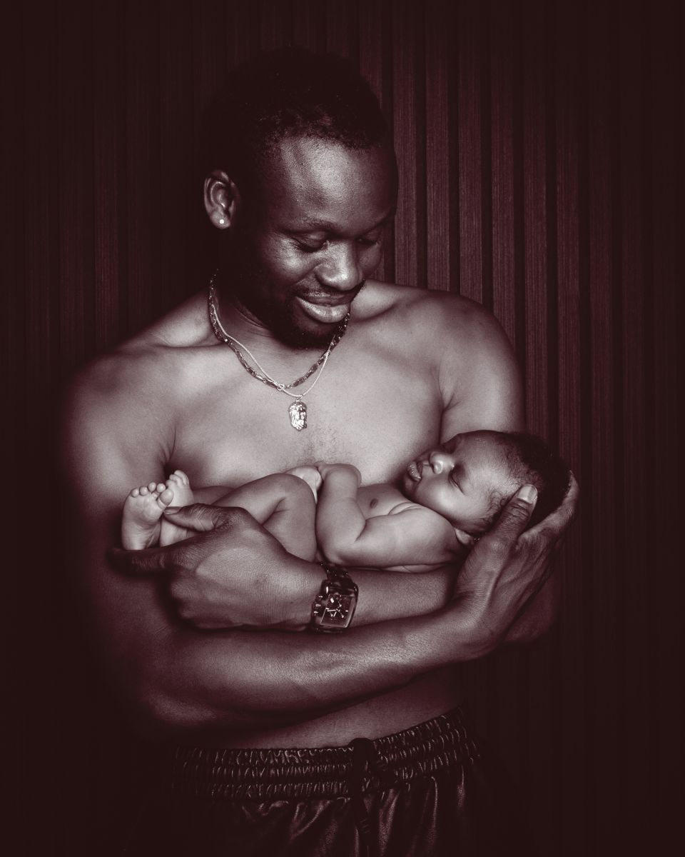 a newborn sharing a skin to skin moment with dad at a photo shoot