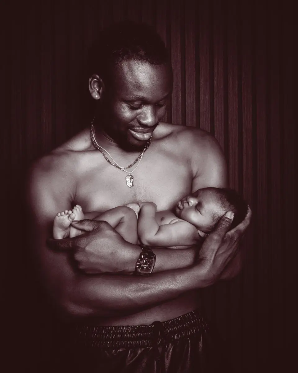 a newborn sharing a skin to skin moment with dad at a photo shoot