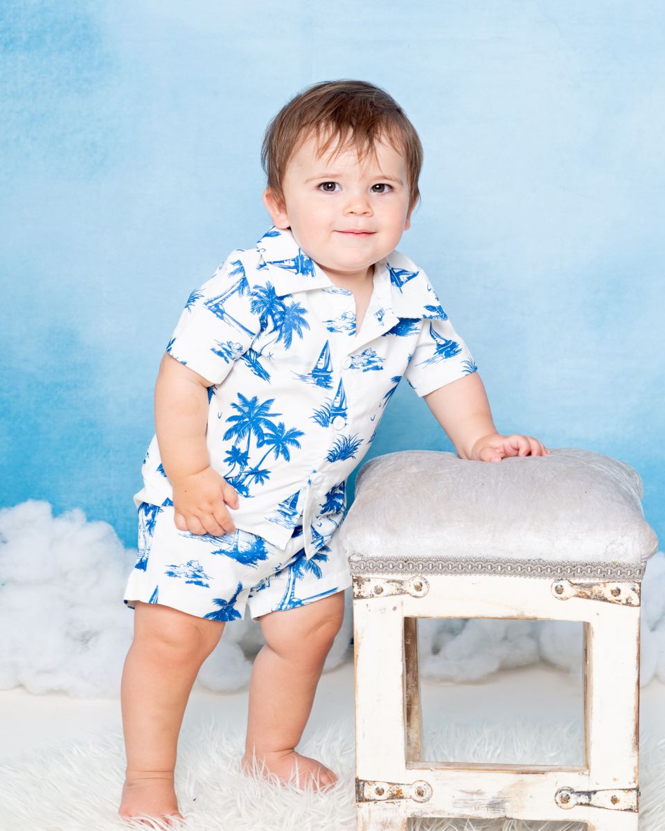 a little boy at a photo shoot in a tropical style outfit