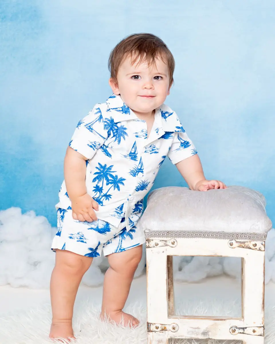 a little boy at a photo shoot in a tropical style outfit