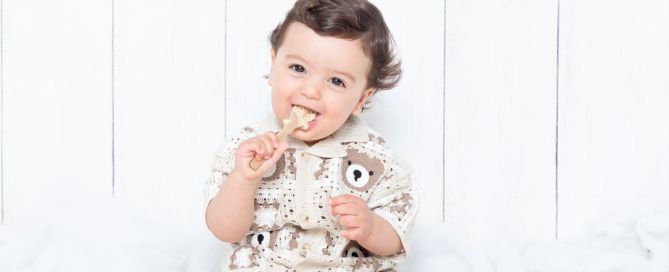 a little boy enjoying a birthday cake in a matching outfit