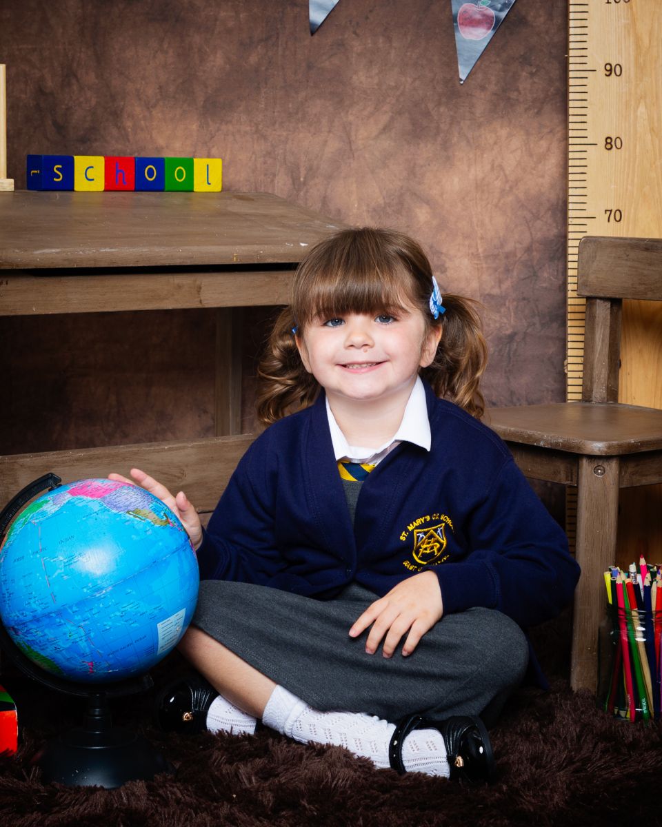 a little girl in a navy cardigan at photo shoot