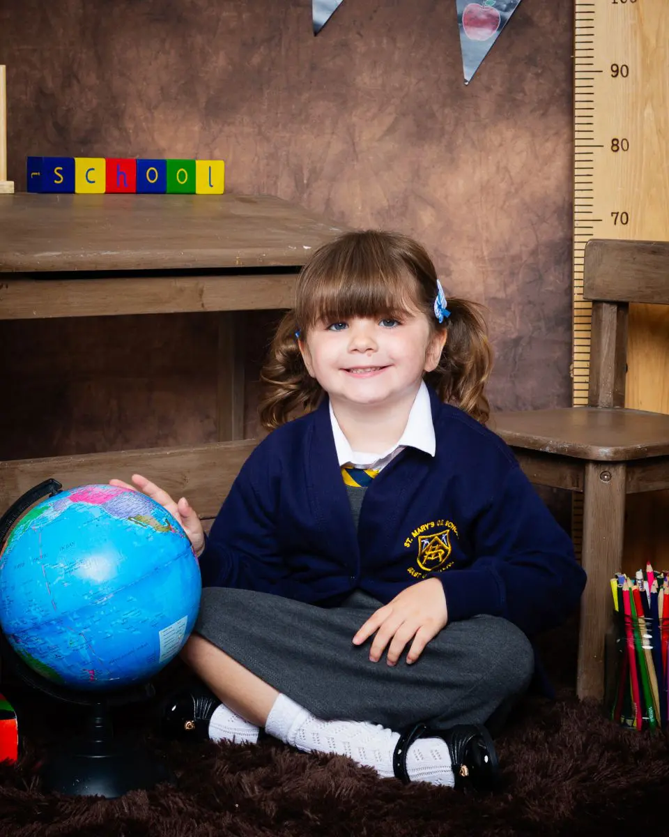Starting School Photo Shoot Event West Sussex Crawley Down a little girl in a navy cardigan at photo shoot