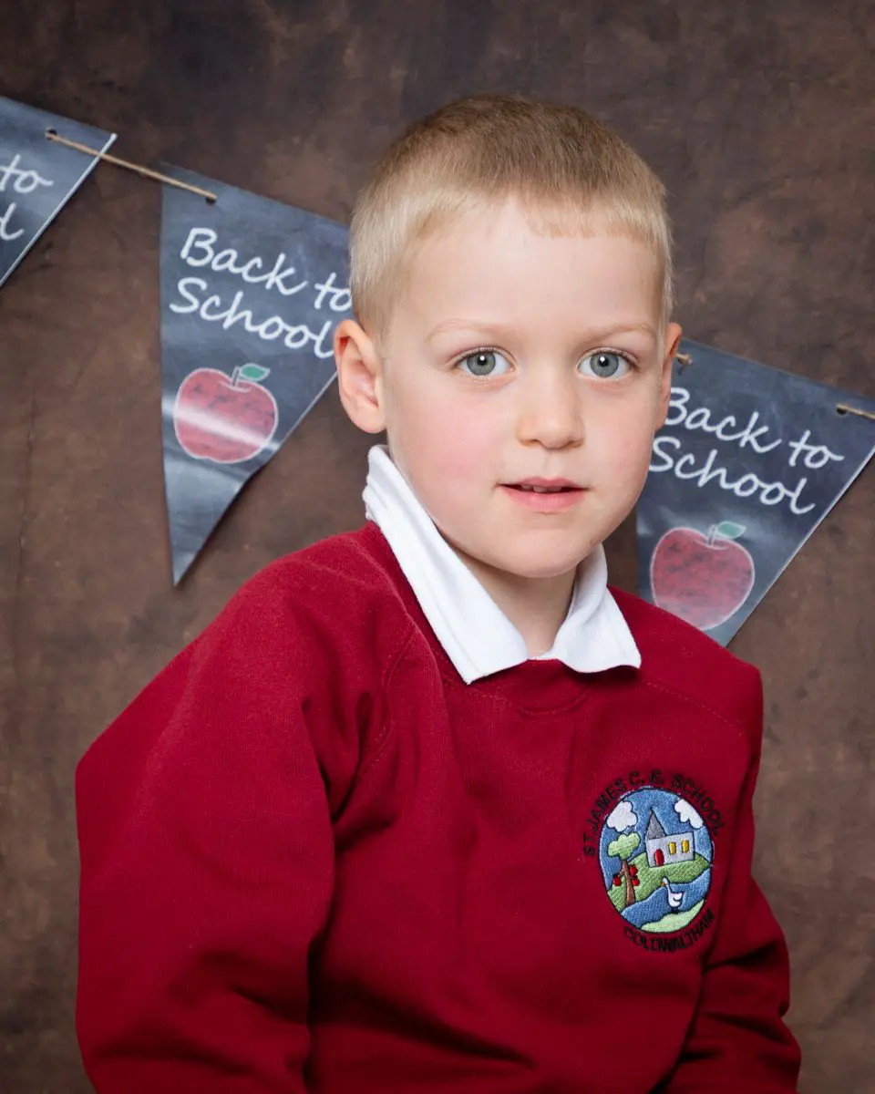 Starting School Photo Shoot Event West Sussex Crawley Down a little boy in a red school jumper at photo shoot