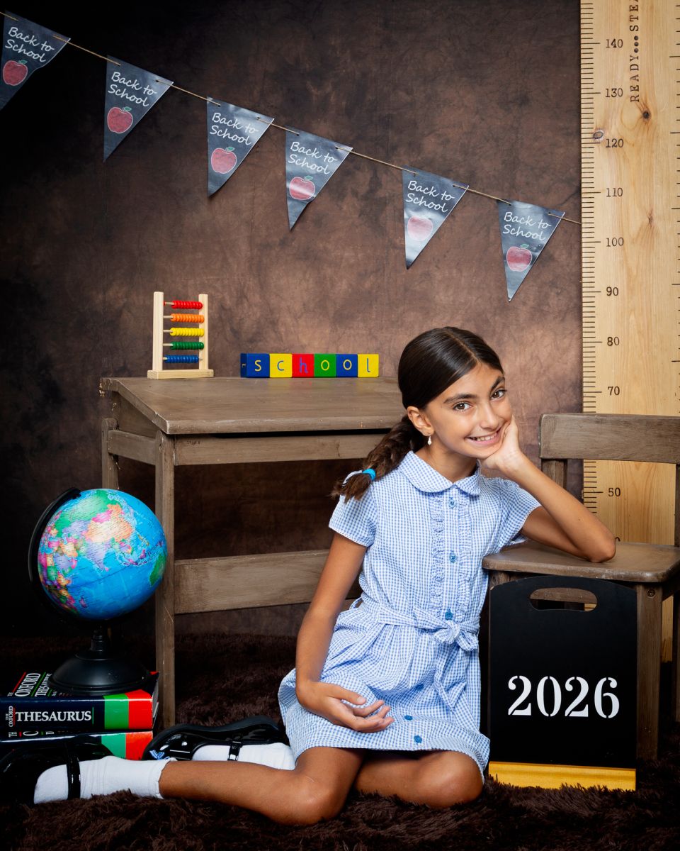 a little girl inblue gingham dress at photo shoot