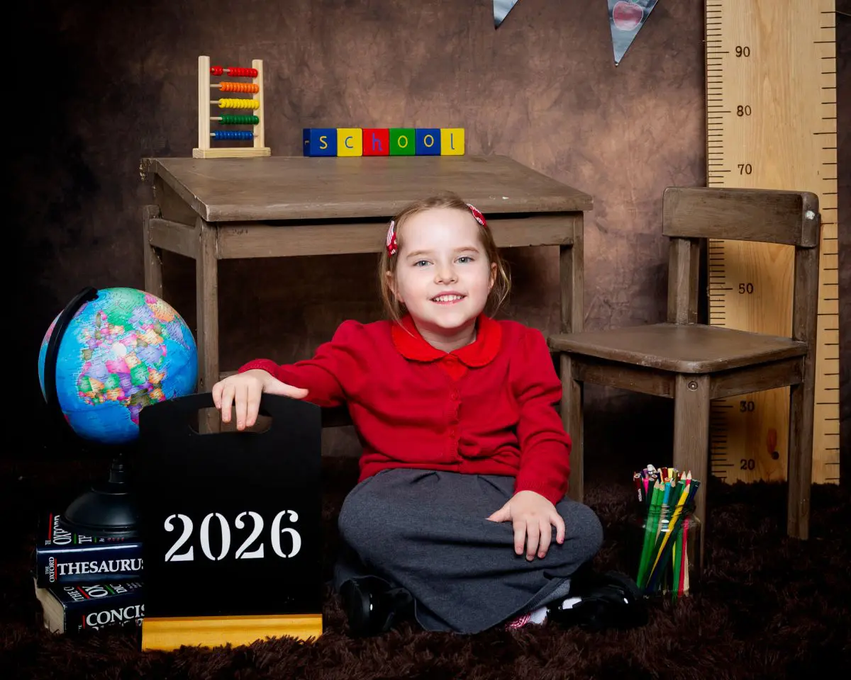 Starting School Photo Shoot Event West Sussex Crawley Down a little girl in a red school jumper at photo shoot