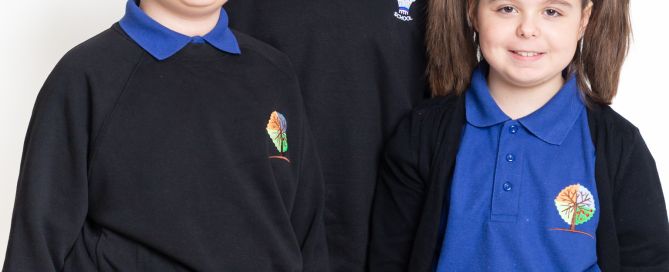 Twins and their older brother pose for a school photo in West Sussex photo studio