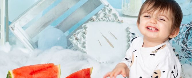 a little boy at a watermelon first birthday photo shoot