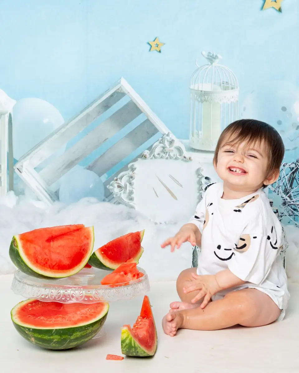 a little boy at a watermelon first birthday photo shoot